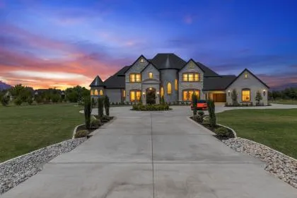 Twilight exterior of the $4.15 million estate at 1850 New Castle Court in Lucas, Texas