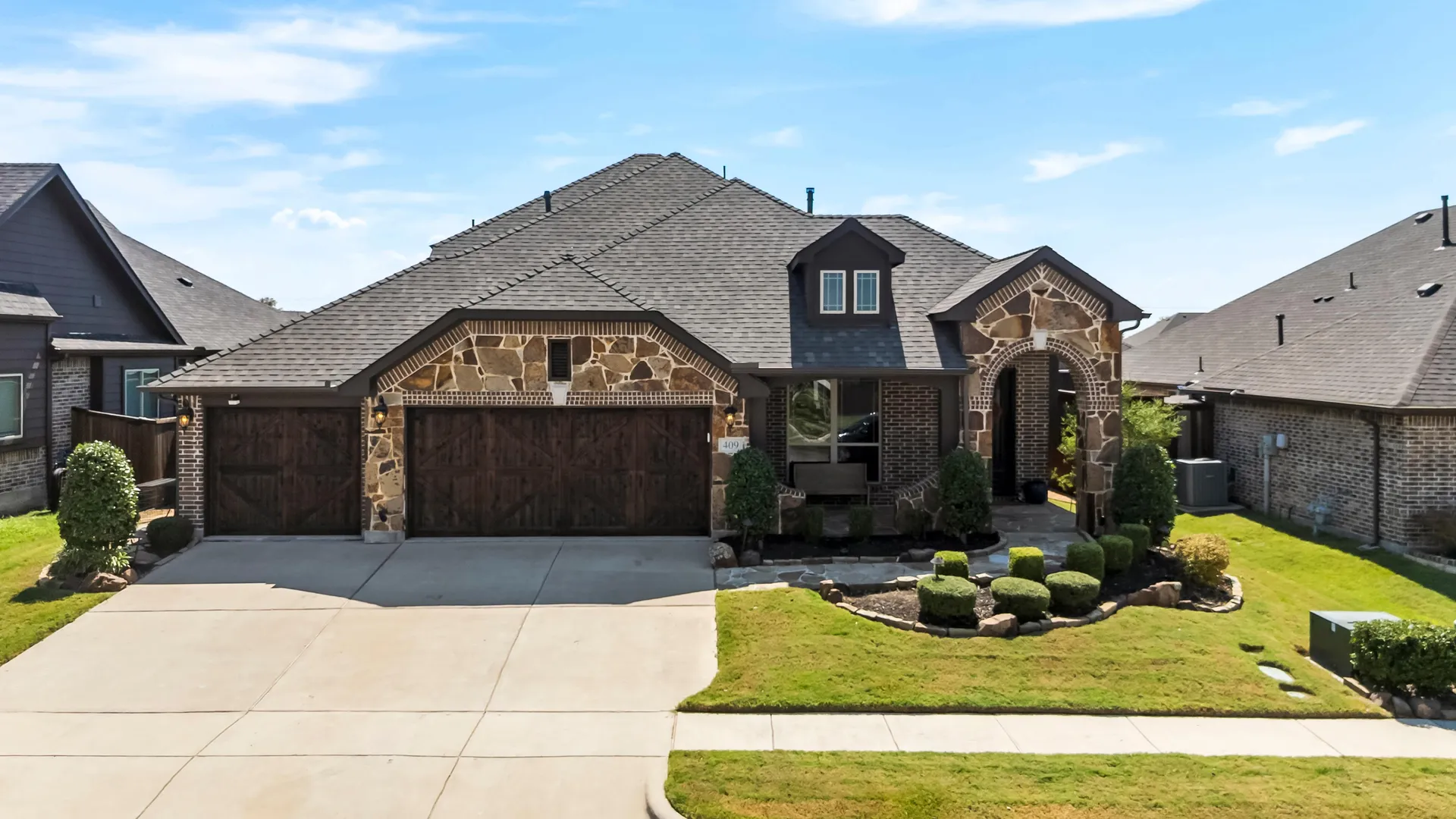 Stone-accented front elevation at 409 Milford Drive in Wylie, Texas